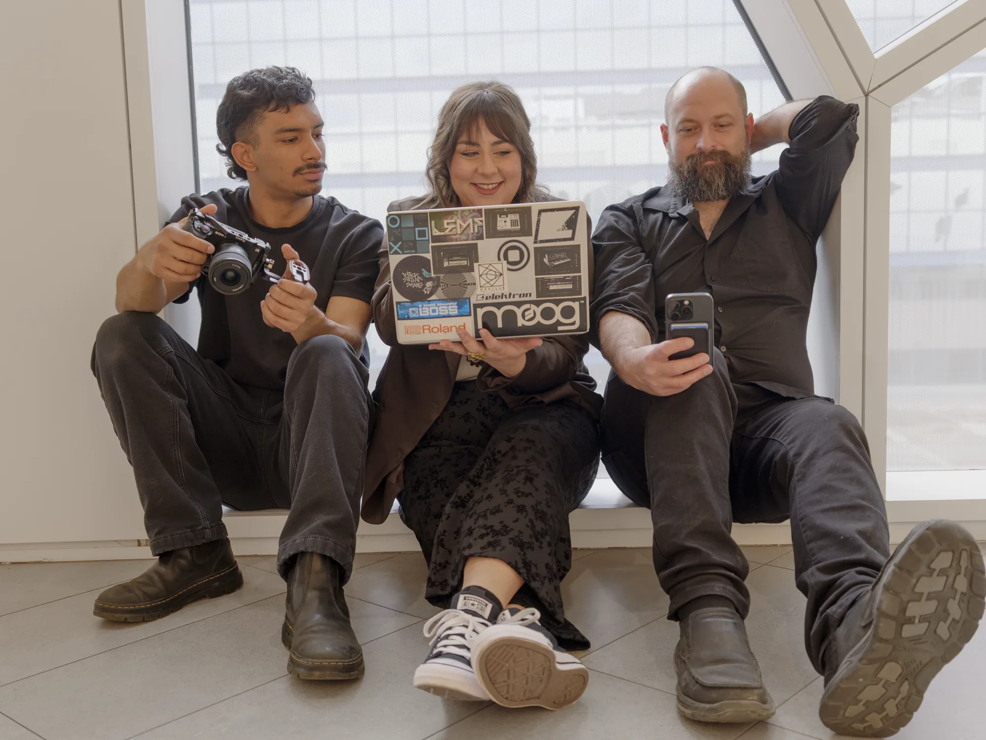 Collective production team in a window-lit planning session